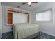Bedroom features a space-saving Murphy bed, built-in shelves, a ceiling fan, and wood-look flooring at 10754 111Th N Pl, Largo, FL 33778