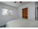 This bedroom features a built-in closet, wood-look flooring, a ceiling fan, and plenty of natural light at 10754 111Th N Pl, Largo, FL 33778