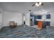 Open concept kitchen and living area with blue cabinets and stainless steel appliances at 10754 111Th N Pl, Largo, FL 33778