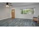 Bright living room with new flooring, a ceiling fan and a view of the front yard at 10754 111Th N Pl, Largo, FL 33778