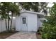 Quaint outbuilding nestled in a private backyard, featuring a clean design and versatile space for storage or hobbies at 10754 111Th N Pl, Largo, FL 33778