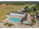 Aerial view showcasing community center with pool, tennis courts, baseball field, and ample parking at 10814 Brickside Ct, Riverview, FL 33579