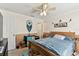 Bedroom featuring a wooden bed, ceiling fan, and decorated walls at 10814 Brickside Ct, Riverview, FL 33579