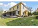 A charming two-story home with a well-maintained lawn and a screened porch at 10814 Brickside Ct, Riverview, FL 33579