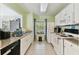 Functional kitchen with white cabinets, granite counters, and essential appliances at 10814 Brickside Ct, Riverview, FL 33579