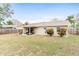Spacious backyard with covered patio and mature trees, providing a serene outdoor living space at 12162 Aurora Ct, Largo, FL 33774