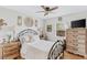 Cozy bedroom with neutral colors, an ornate iron bed frame, and a view of the outdoor greenery at 12162 Aurora Ct, Largo, FL 33774
