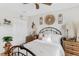 Calm bedroom with an iron bed frame, decorative wall clocks, and rustic wooden furniture at 12162 Aurora Ct, Largo, FL 33774