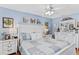 Bright bedroom featuring blue walls, a decorative bed, and matching bedside tables with lamps at 12162 Aurora Ct, Largo, FL 33774