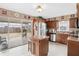 Spacious kitchen with stainless steel appliances, a central island, and sliding glass doors to the backyard at 12162 Aurora Ct, Largo, FL 33774