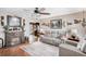 Cozy living room with stone fireplace, comfortable seating, wood floors, and natural light creates a relaxing space at 12162 Aurora Ct, Largo, FL 33774