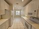 Well-lit kitchen featuring white cabinets, tile floors, and a full suite of appliances at 12703 Aston Creek Dr, Tampa, FL 33626