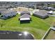 Aerial view of the home with a screened lanai and expansive lawn backing onto a beautiful lake at 13006 Tidal Flats Loop, Riverview, FL 33579