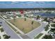 A high aerial view displays a community with a lake, green space, and houses on a sunny day at 13006 Tidal Flats Loop, Riverview, FL 33579