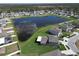 A panoramic aerial view of the home showcasing the large pond, spacious backyard, and neighborhood at 13006 Tidal Flats Loop, Riverview, FL 33579