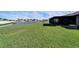 Expansive backyard with lawn and pond views, perfect for outdoor enjoyment and relaxation at 13006 Tidal Flats Loop, Riverview, FL 33579