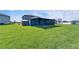 Spacious backyard featuring a screened lanai, providing ample space for outdoor enjoyment at 13006 Tidal Flats Loop, Riverview, FL 33579