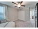 Bedroom featuring a ceiling fan, plush neutral carpet and a large closet at 13006 Tidal Flats Loop, Riverview, FL 33579