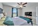Bedroom with ceiling fan and window, creating a bright and airy space at 13006 Tidal Flats Loop, Riverview, FL 33579