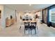 View of dining area featuring modern furnishings, accent wall, and view into bright open kitchen at 13006 Tidal Flats Loop, Riverview, FL 33579