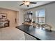 A dining room with a long table, four chairs, a ceiling fan, and storage in the corner at 13006 Tidal Flats Loop, Riverview, FL 33579
