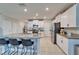 This kitchen has white cabinets, granite countertops, stainless steel appliances, and kitchen island with chairs at 13006 Tidal Flats Loop, Riverview, FL 33579