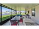 Lanai with outdoor dining area, TV, grill, and serene views of the pond at 13006 Tidal Flats Loop, Riverview, FL 33579