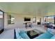 Covered lanai with outdoor seating, TV, grill, and a cozy atmosphere for entertaining at 13006 Tidal Flats Loop, Riverview, FL 33579