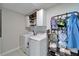 Functional laundry room with modern washer and dryer, ample storage, and convenient shelving at 13006 Tidal Flats Loop, Riverview, FL 33579