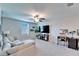 Comfortable living room includes neutral paint, modern ceiling fan, large sectional, and contemporary desk at 13006 Tidal Flats Loop, Riverview, FL 33579