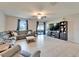 Inviting living room with comfortable seating, a large TV, and sliding glass doors to the patio at 13006 Tidal Flats Loop, Riverview, FL 33579