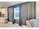 Living space featuring modern window treatments and decorative wall, adjoining updated kitchen with breakfast bar at 13006 Tidal Flats Loop, Riverview, FL 33579