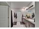 Well-lit main bathroom with a double vanity, granite countertops, and a walk-in shower at 13006 Tidal Flats Loop, Riverview, FL 33579