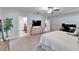 Spacious main bedroom showcasing a TV, office setup, and en-suite bathroom entrance at 13006 Tidal Flats Loop, Riverview, FL 33579