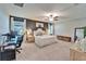 Serene main bedroom with plush carpeting, a ceiling fan, and a comfortable work area at 13006 Tidal Flats Loop, Riverview, FL 33579