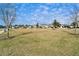 A neighborhood with green lawns, mature trees and sidewalks in a Gathering friendly community setting at 13006 Tidal Flats Loop, Riverview, FL 33579