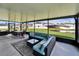 Relaxing screened-in patio with comfortable seating and a beautiful view of the backyard at 13006 Tidal Flats Loop, Riverview, FL 33579