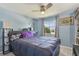 Comfortable bedroom with a ceiling fan, light blue walls, and a large window at 1301 Melonwood Ave, Clearwater, FL 33759