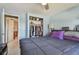 Bedroom with blue walls, featuring a ceiling fan, and a view into another room from the bed at 1301 Melonwood Ave, Clearwater, FL 33759