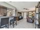 Cozy living room featuring tile floors, leather recliners, and a bar area with seating at 1301 Melonwood Ave, Clearwater, FL 33759