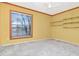 Bedroom with a ceiling fan, window, and closet shelves, painted in yellow at 1321 N Mcmullen Booth Rd # 1321, Clearwater, FL 33759
