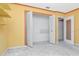Bedroom with open closet, doors, shelves, painted in yellow and white at 1321 N Mcmullen Booth Rd # 1321, Clearwater, FL 33759