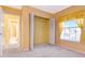 Bedroom with closet and view to the bathroom, featuring yellow striped wallpaper at 1321 N Mcmullen Booth Rd # 1321, Clearwater, FL 33759