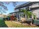 View of the exterior of the home featuring some tropical plants at 1321 N Mcmullen Booth Rd # 1321, Clearwater, FL 33759