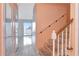 Interior hallway featuring tile flooring, stairs and mirrors, leading to an airy, sunlit room at 1321 N Mcmullen Booth Rd # 1321, Clearwater, FL 33759