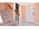 Interior hallway showcasing tiled flooring and carpeted stairs leading up to the next level at 1321 N Mcmullen Booth Rd # 1321, Clearwater, FL 33759