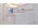 A stylish kitchen featuring white cabinets, tiled floor, and a breakfast bar with seating at 1321 N Mcmullen Booth Rd # 1321, Clearwater, FL 33759