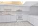 A well-lit kitchen featuring white cabinets, modern appliances, and ample counter space at 1321 N Mcmullen Booth Rd # 1321, Clearwater, FL 33759