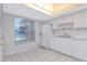 Clean kitchen featuring white appliances, tile flooring, and bright lighting at 1321 N Mcmullen Booth Rd # 1321, Clearwater, FL 33759