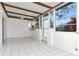 Sunroom patio with white tile floor, exposed beams, and multiple windows for natural light at 1321 N Mcmullen Booth Rd # 1321, Clearwater, FL 33759